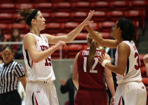 Kim Raff  |  The Salt Lake Tribune
University of Utah player (left) Michelle Plouffe high fives Ciera Dunbar after sinking a three pointer during a game against Washington State at the Huntsman Center in Salt Lake City on February 24, 2013. Utah went on to win 59-47.