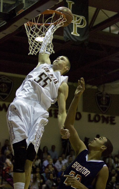 Kim Raff  |  The Salt Lake Tribune
(left) Lone Peak player Eric Mika dunks the ball over the head of Brighton player Tremaine Nisson for a loose ball during a game at Lone Peak High School in Highland on November 28, 2012. Lone Peak went on to win the game.