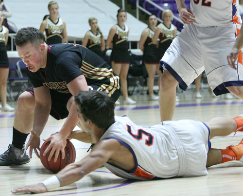 Paul Fraughton  |   Salt Lake Tribune
Mountain Crest's FEddy Hall goes to the floor fighting Maple Mountain's Drew Bates for the loose ball.
 Tuesday, February 26, 2013