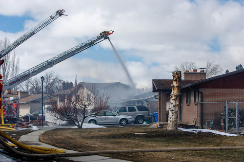 Trent Nelson  |  The Salt Lake Tribune
Fire crews work to contain a house fire on Dimond Drive Tuesday, February 26, 2013 in West Jordan.