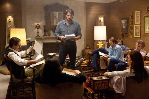 This film image released by Warner Bros. Pictures shows Ben Affleck as Tony Mendez, center, in "Argo,"  a rescue thriller about the 1979 Iranian hostage crisis. "Argo" opens this weekend. The Salt Lake Tribune's Sean Means calls the movie "an exciting thriller that melds spy intrigue with human-scaled drama and Hollywood-industry comedy." (AP Photo/Warner Bros., Claire Folger)