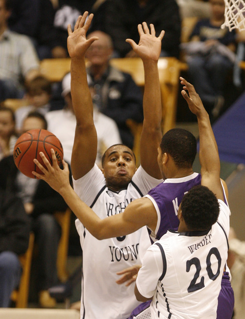 Rick Egan  | The Salt Lake Tribune 

Brigham Young Cougars forward Brandon Davies (0) tries to stop Portland's Kevin Bailey,as Brigham Young Cougars guard Anson Winder (20) lends a hand on defense, in basketball action, as the BYU Cougars played the Portland Pilots, at the Marriott Center, Saturday, February 16, 2013.