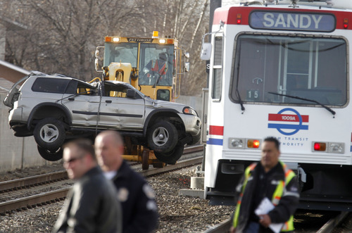 Al Hartmann  |  Tribune file photo
Legislation that cleared the Legislature means questions about driving near trains should end up on tests for new drivers. In this file photo from February, UTA crews clear an SUV that was hit in a TRAX accident near 5900 South 300 West.