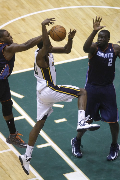 Chris Detrick  |  The Salt Lake Tribune
Utah Jazz point guard Alec Burks (10) shoots past Charlotte Bobcats small forward Jeff Adrien (4) and Charlotte Bobcats center DeSagana Diop (2) during the first half of the game at EnergySolutions Arena Friday March 1, 2013.