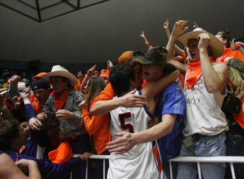 Kim Raff  |  The Salt Lake Tribune
Mountain Crest fans hug Mountain Crest's Eddy Hall after defeating Logan 54-51during the 4A state semifinal game at the Dee Event Center in Ogden on March 1, 2013.