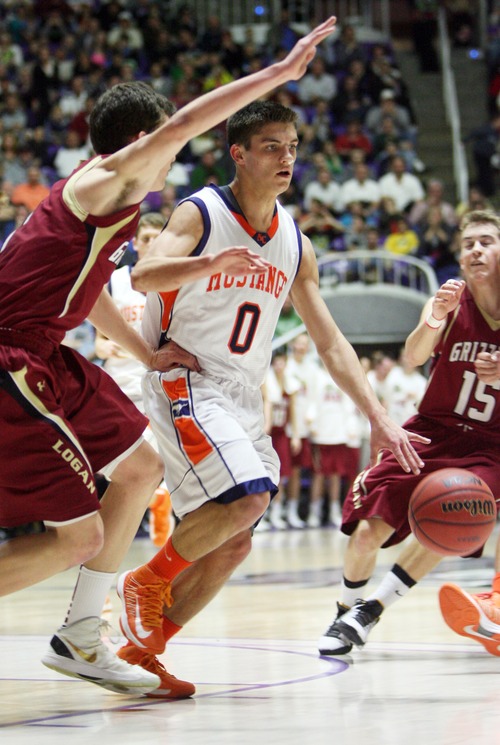 Kim Raff  |  The Salt Lake Tribune
Mountain Crest's Tyler Crosbie looks to pass as he is guarded by (left) Logan's Brett Dickson during the 4A state semifinal game at the Dee Event Center in Ogden on March 1, 2013. Mountain Crest went on to win 54-51.