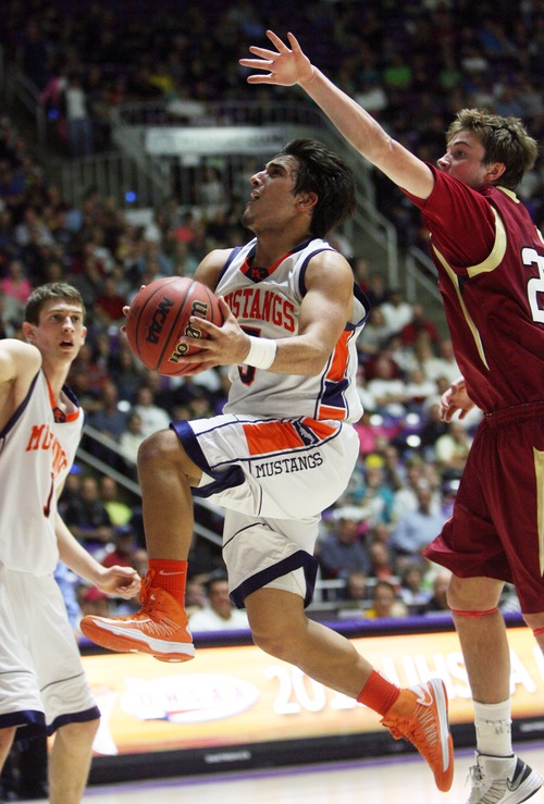 Kim Raff  |  The Salt Lake Tribune
Mountain Crest's (left) Eddy Hall takes a shot as (right) Logan's Luke Falk defends during the 4A state semifinal game at the Dee Event Center in Ogden on March 1, 2013. Mountain Crest went on to win 54-51.