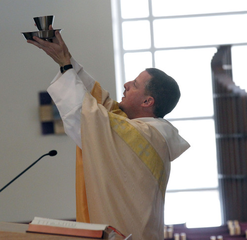 Al Hartmann  |  The Salt Lake Tribune
Father Carl Schlichte of St. Catherine of Siena Catholic Newman Center at the University of Utah serves communion during a Mass on Thursday marking the retirement of Pope Benedict XVI.