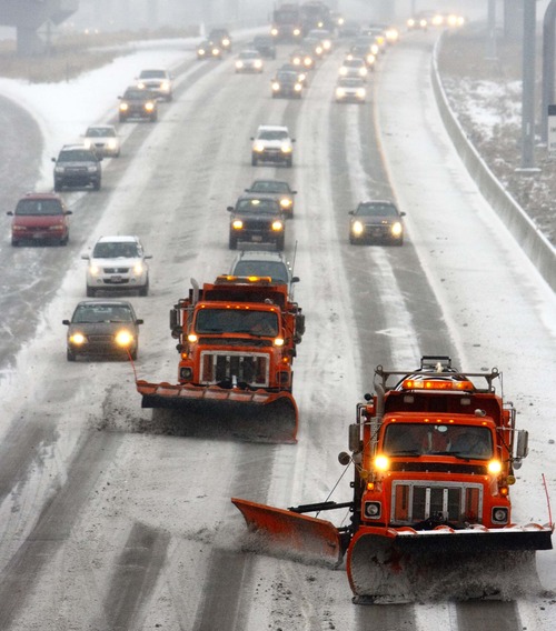 Trent Nelson  |  The Salt Lake Tribune
Snowplows clear snow on Interstate 15 on Tuesday near the 2700 South overpass.