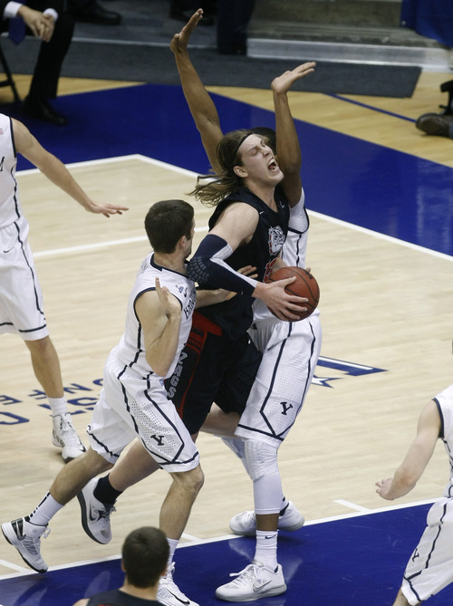 Chris Detrick  |  The Salt Lake Tribune
Gonzaga Bulldogs forward Kelly Olynyk (13) is fouled by Brigham Young Cougars forward Brandon Davies (0) during the first half of the game at the Marriott Center Thursday February 28, 2013. Gonzaga is winning the game 35-31 at halftime.
