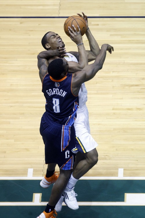 Chris Detrick  |  The Salt Lake Tribune
Utah Jazz point guard Alec Burks (10) is fouled by Charlotte Bobcats shooting guard Ben Gordon (8) during the first half of the game at EnergySolutions Arena Friday March 1, 2013.