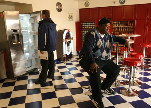 Leah Hogsten  |  The Salt Lake Tribune
"This is a blessing," said Charles Oliver (right) of the community kitchen as Garie Spence (left) checks out the new refrigerator. Veterans living at Freedom Landing check out their new community kitchen Friday, March 1, 2013 where residents will be able to socialize and prepare healthier meals. 
Freedom Landing is housing for homeless veterans in an old Day's Inn Extended Stay Hotel that was converted to apartments about three years ago. It's a venture of the Housing Authority of Salt Lake City and Department of Veterans Affairs.