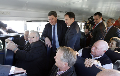 Francisco Kjolseth  |  The Salt Lake Tribune
Gov. Gary R. Herbert, center, packs himself, legislators and the press into a CNG school bus parked next to the Capitol on Monday, March 4, 2013 for an announcement. The governor re-affirmed his call for state and local government, schools, public transit, businesses and industry to transition more of their fleet to clean fuel vehicles, as bill SB275 initiates a process to target heavy vehicle and fleet emissions.