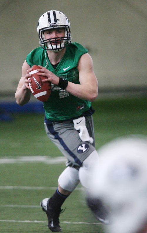 Steve Griffin | The Salt Lake Tribune

BYU quarterback, Taysom Hill, rolls out to pass during spring practice at the indoor practice facility at BYU in Provo, Utah Monday March 4, 2013.