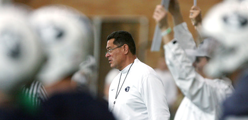 Steve Griffin | The Salt Lake Tribune

BYU assistant head coach, Robert Anae, works with players during spring practice at the indoor practice facility at BYU in Provo, Utah Monday March 4, 2013.
