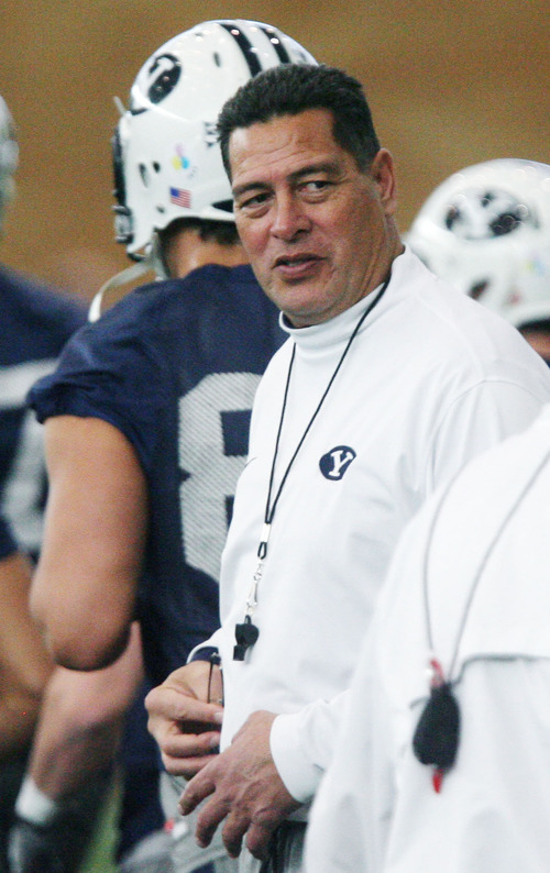 Steve Griffin | The Salt Lake Tribune

BYU assistant head coach, Robert Anae, works with players during spring practice at the indoor practice facility at BYU in Provo, Utah Monday March 4, 2013.