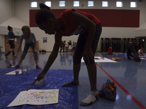 Leah Hogsten  |  The Salt Lake Tribune
Sonya Banza likes bright colors because they put her in a happy mood, she said. Fox Hollow Elementary Principal Kevin Pullan instructs fourth grade students on creating their own masterpieces in the school gym.