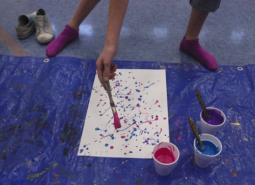 Leah Hogsten  |  The Salt Lake Tribune
Mekenzie Hawker creates her painting. Fox Hollow Elementary School Principal Kevin Pullan, an abstract painter, instructed students on creating their own masterpieces in the school gym on Wednesday, March 6, 2013.