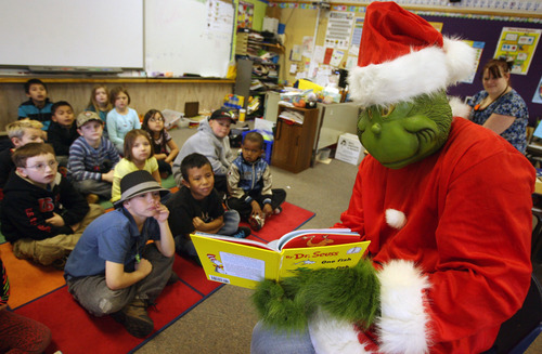 Steve Griffin  |  The Salt Lake Tribune
Dressed as the Grinch, Colton Spencer, of JC Penny Shared Services, reads to second graders in Rebecca Kemp's class at Oquirrh Hills Elementary school in Kearns. Volunteers were at the school reading Dr. Seuss books to students to celebrate the author's birthday.
