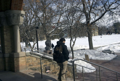 Kim Raff  |  The Salt Lake Tribune
A Utah State University student walks out of the Old Main on campus in Logan on February 25, 2013. Utah State University is stepping up recruitment of out-of-state students to make up for lower enrollment numbers after the lowering of the missionary age.