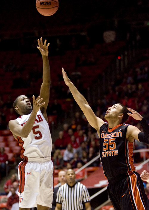 Kim Raff  |  The Salt Lake Tribune
(left) Utah Utes guard Jarred DuBois (5) shoots the ball as Oregon State Beavers guard Roberto Nelson (55) defends during a game at the Huntsman Center in Salt Lake City on March 7, 2013. Utah went on to win 72-61.