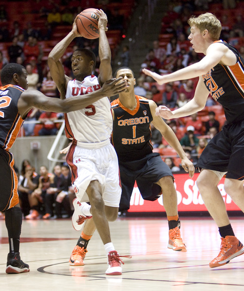 Kim Raff  |  The Salt Lake Tribune
Utah Utes guard Jarred DuBois (5) looks to pass as he is surrounded by (from left) Oregon State Beavers forward Jarmal Reid (32), Victor Robbins (1) and Olaf Schaftenaar (30) during a game at the Huntsman Center in Salt Lake City on March 7, 2013. Utah went on to win 72-61.