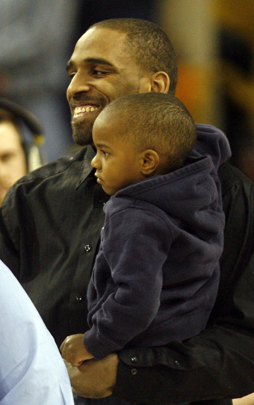 Rick Egan  | The Salt Lake Tribune 

Kyisean Reed smiles as he is recognized as an out-going senior, before the Aggies faced the University of Texas at San Antonio Roadrunners, in Logan, Saturday, March 9, 2013. He is holding his nephew.