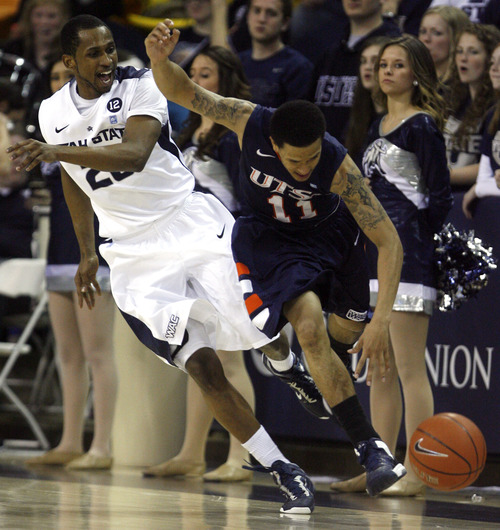 Rick Egan  | The Salt Lake Tribune 

Utah State Aggies guard TeNale Roland (20) goes after the ball along with Texas-San Antonio Roadrunners guard Michael Hale III (11), in basketball action as the Aggies faced the University of Texas at San Antonio Roadrunners, in Logan, Saturday, March 9, 2013.