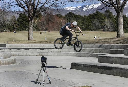 Scott Sommerdorf   |  The Salt Lake Tribune
Jeff Tabb, visiting from Detroit made videos of himself and friend Colin Payne doing tricks on their bikes near the Liberty Park pond, as Sunday brought Spring-like weather to Salt Lake, Sunday, March 10, 2013.