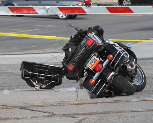 Rick Egan  | The Salt Lake Tribune 

A motorcycle lies on its side after colliding with a TRAX train on 7700 South, Monday, March 11, 2013.