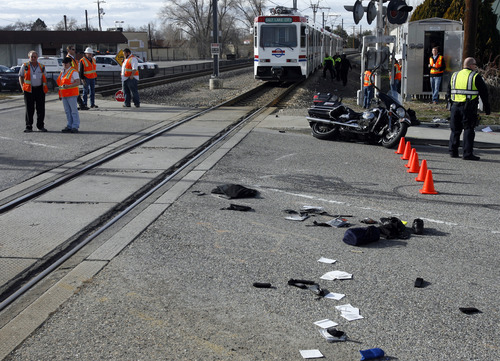 Rick Egan  | The Salt Lake Tribune 

A motorcycle sits near the edge of the tracks, after colliding with a TRAX train on 7700 South, Monday, March 11, 2013.