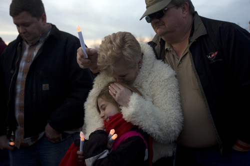 Kim Raff  |  The Salt Lake Tribune
Sherrie Crouch and Milne Crouch, right, pray with their granddaughter, Rya Smith, during a vigil for the Crouches' granddaughter, 15-year old Anne Kasprzak, at the bridge near where she was found dead a year ago.