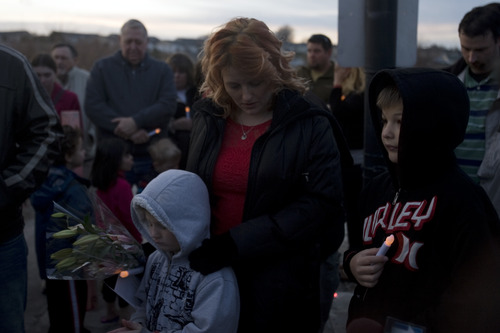 Kim Raff  |  The Salt Lake Tribune
Veronica Kasprzak, center, listens during a vigil for her 15-year old daughter Anne Kasprzak at the bridge near where she was found dead last year on the Jordan River Parkway Trail in Draper. Last week, Draper police announced they had cleared two men they arrested, but never charged, for the crime. Anne's family is hoping someone will come forward with information about her murder.