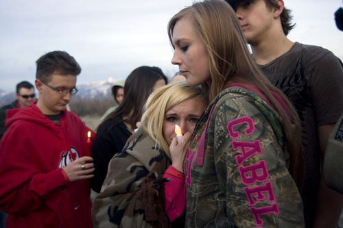Kim Raff  |  The Salt Lake Tribune
Kylie Clark, center, and Lyndsee West comfort each other during a vigil for their 15-year old friend Anne Kasprzak at the bridge where she was found dead one year earlier on the Jordan River Parkway Trail in Draper on March 10, 2013. Kasprzak's parents are now saying they don't think police arrested the right men for killing her. They hope the vigil will eliciting new leads.