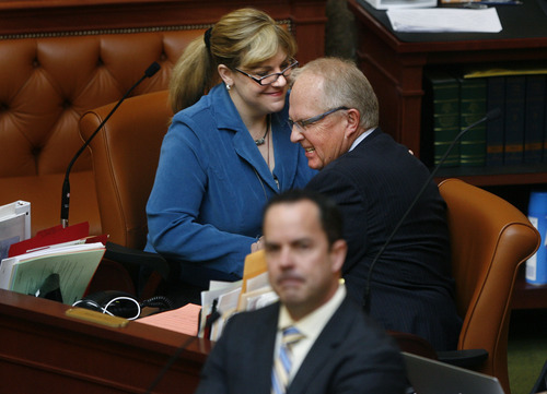Scott Sommerdorf   |  The Salt Lake Tribune
Rep. Jennifer Seelig, D-Salt Lake City, left, and Rep. Mike Noel, R-Kanab, congratulate one another on stripping a prison privatization provision from HB72S6 -- the Prison Relocation and Development Amendments. In the foreground is Rep. Brad Wilson, R-Kaysville, floor sponsor of the bill.