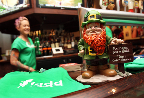 Francisco Kjolseth  |  The Salt Lake Tribune
The Utah Highway Patrol is partnering with dozens of bars across the Wasatch Front, including Lumpy's, to unveil Leprechauns Against Drunk Driving, to remind patrons about safe, alcohol-free driving for the St. Patrick's Day weekend. Bars will display leprechaun statuettes and servers will be wearing green T-shirts bearing the Leprechauns Against Drunk Driving message. At left is bartender Tiffany Rackham with one of the "ladd" shirts.