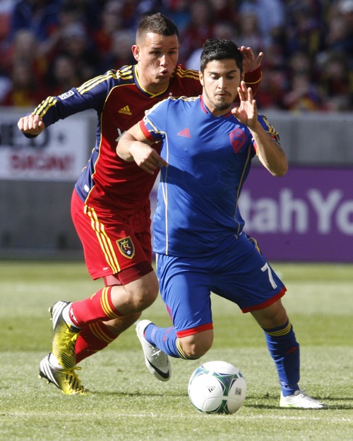Rick Egan  | The Salt Lake Tribune 

Real Salt Lake midfielder Luis Gil (21) goes after Colorado Rapids forward Kevin Harbottle (7), in MLS soccer action, at RIo Tinto Stadium, Saturday, March 16, 2013.