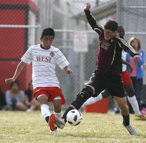 Rick Egan  | The Salt Lake Tribune 

#4 West High gets goes for the ball, along with Tyler Allison (25), in prep soccer action Lone Peak vs. West, at West High, Monday, March 11, 2013.