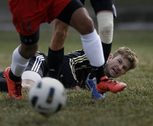 Rick Egan  | The Salt Lake Tribune 

Tyler Hutchinson watches the ball get away after he was knocked to the ground, in prep soccer action Lone Peak vs. West, at West High, Monday, March 11, 2013.