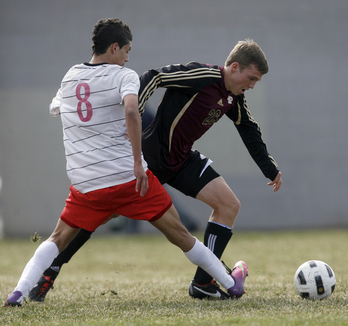 Rick Egan  | The Salt Lake Tribune 

Nathan Henley (26) Lone Peak, tries to get past Raul Cerrato (8) West, in prep soccer action Lone Peak vs. West, at West High, Monday, March 11, 2013.