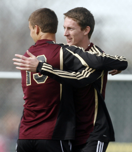 Rick Egan  | The Salt Lake Tribune 

Patrick Puchs (13) congratulates Kurtis Brimhall, (17), after he scored a goal for Lone Peak, in prep soccer action Lone Peak vs. West, at West High, Monday, March 11, 2013.