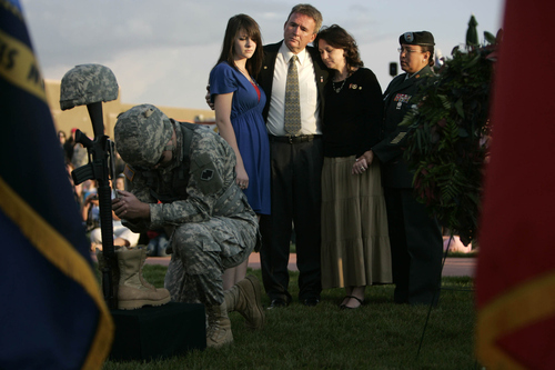 Jim Urquhart | The Salt Lake Tribune

The Jordan Thibeault family of South Jordan--Jordan's sister Denise, father John and mother Celeste--embrace during a memorial to fallen soldiers during a September 11th memorial service Thursday, September 11, 2008 in front of the Sandy City hall. Kneeling at the memorial at left is US Army Reserve Specialist Scott Mickiewicz and comforting the family at right is SFC Maria Braman of the US Army. Jordan's name was called out repeatedly as part of a roll call to signify he has fallen. Jordan Thibeault was 22 when he died September 5, 2008, while serving in Iraq.   -- 9/11/08 (Jim Urquhart/The Salt Lake Tribune)