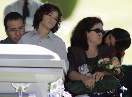 Trent Nelson | The Salt Lake Tribune

Patricia Olmos, right, is comforted by her daughter Samantha Acosta, 8, during the funeral service September 22, 2004 in the Spanish Fork City Cemetery for Olmos' son, Cesar Machado-Olmos, a U.S. Marine killed in Iraq. At left is Cesar's stepfather Esau Acosta and younger brother Esau Acosta, 11.