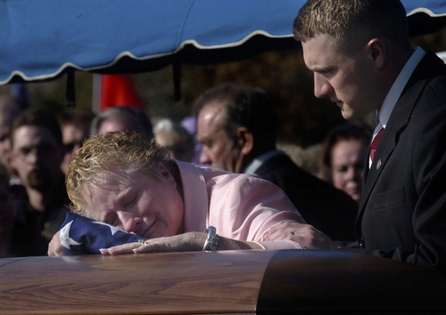 Tribune file photo

Colleen Parkin, mother of Marine Cpl. Matthew Reed Smith, mourns over his casket with son Cory Smith at right, during the graveside funeral at the Salt Lake City Cemetary, Saturday February 4, 2005.  Smith died in a helicopter crash in Iraq.