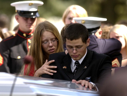 Leah Hogsten | The Salt Lake Tribune

Adam Allred is comforted by a family member at the casket of his brother, Lance Corporal Michael Jacob Allred, who was killed with five fellow U. S. Marines when the Humvee they were in was bombed by a suicide bomber in Fallujah, Iraq on Labor Day, Sept 6, 2004.