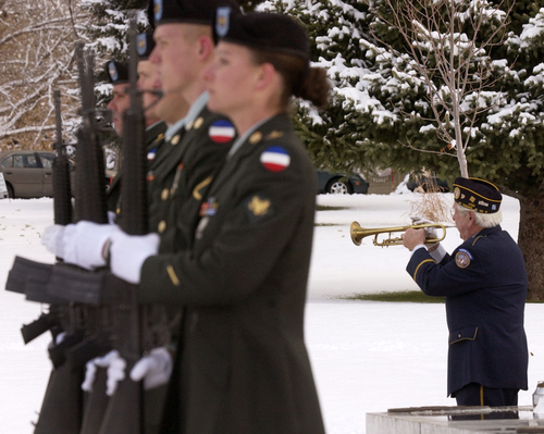 Steve Griffin | The Salt Lake Tribune

 As members of the funeral detail of the 59th Quarter Master from Fort Carson, CO  stand at attention, World War II veteran Tuck Marcantonio plays taps during funeral services November 26, 2003 at Memorial Cemetary in Salt Lake City, for Capt. Nathan Dalley, who died of non-combat wounds in Baghdad.