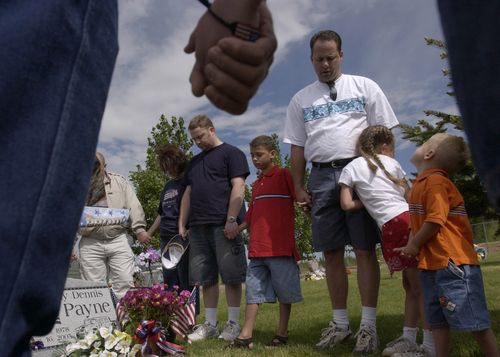Leah Hogsten | The Salt Lake Tribune

The family of Sgt. Rocky Payne who was killed in Iraq in March 2005, spent Monday remembering their son and brother as a Blue Star family. Son Jacob and daughter Kenzie (right) are concerned for their father as Ricky Payne's voice breaks with emotion during his prayer in honor of his fallen military brother Sgt. Rocky Payne. R-L from Ricky is his son Austin, brother Russell and sister-in-law Marcy. 
Photo by Leah Hogsten 5/30/05 Howell