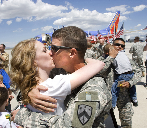 Al Hartmann/The Salt Lake Tribune

Specialist Alan Pentico of Spanish Fork  kisses his wife Lynsie as they reunite Wednesday May 28, 2008 at the Utah Air National Guard Base.  About 130 soldiers from First Battalion, 145th Field Artillery, Utah National Guard returned home from Iraq.