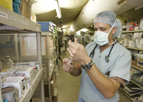 Rick Egan | The Salt Lake Tribune

American Fork native, Capt. Rob Scholes, prepares for surgery in the operating room at the Air Force Theater Hospital at Balad Airforce Base, Iraq October 12, 2005.