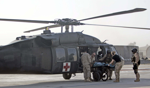 Rick Egan | The Salt Lake Tribune

Hospital workers transport a patient from the medical Helicopter to the Airforce Theater Hospital at Balad Airforce Base, Iraq October 1, 2005.
